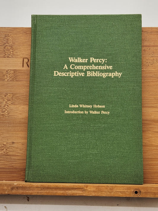 First edition of Walker Percy: A Comprehensive Descriptive Bibliography by Linda Whitney Hobson, signed by both the author and publisher, Rhoda Faust