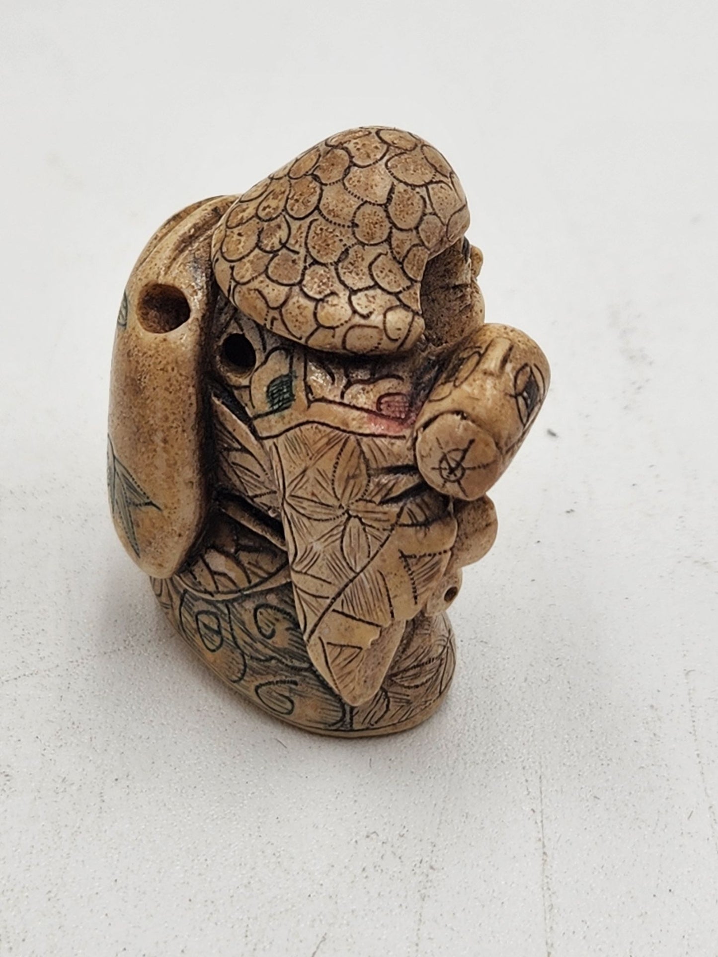 Netsuke Figurine Guy with a Mallet Crouching with a Bag