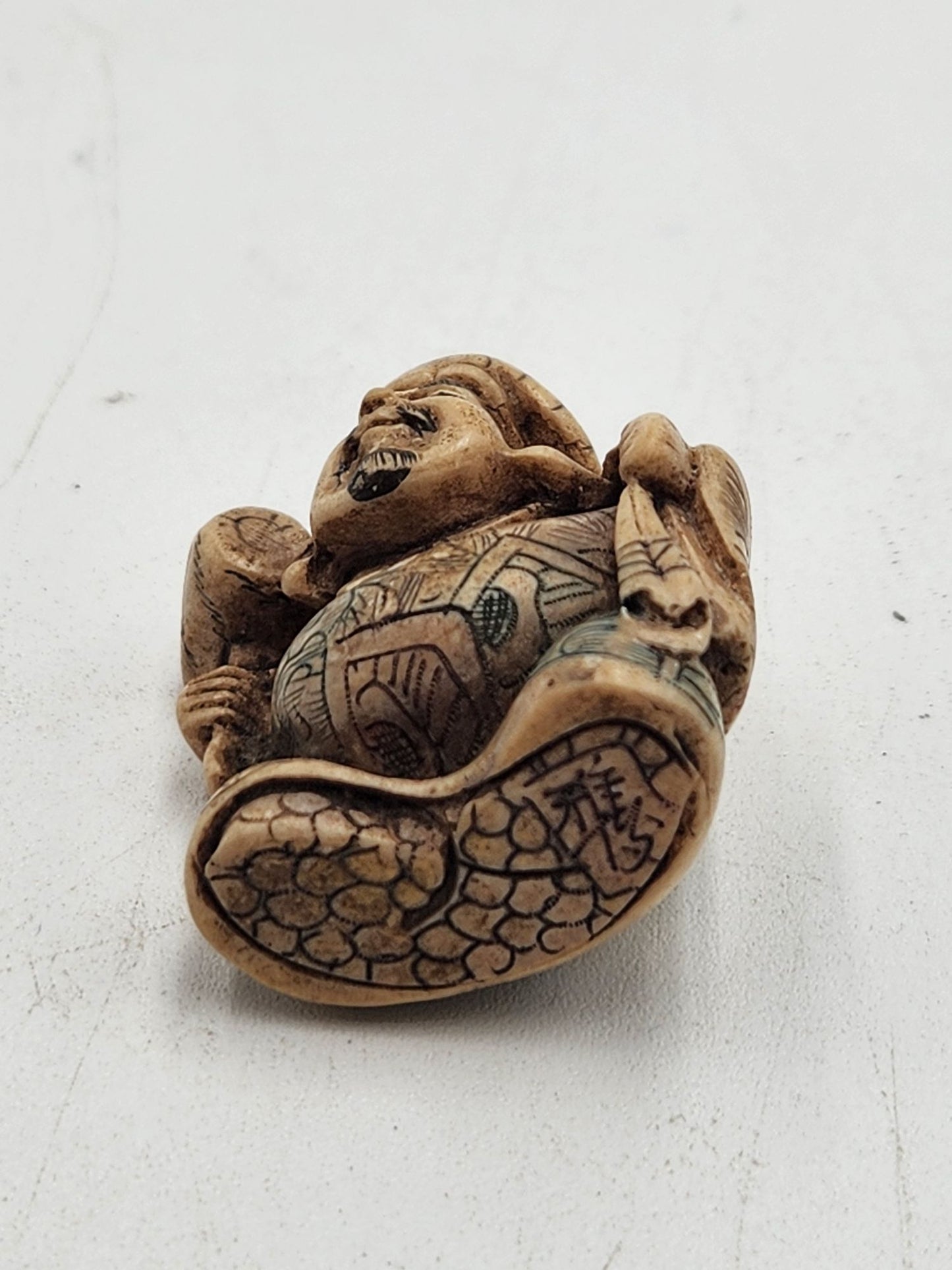 Netsuke Figurine Guy with a Mallet Crouching with a Bag