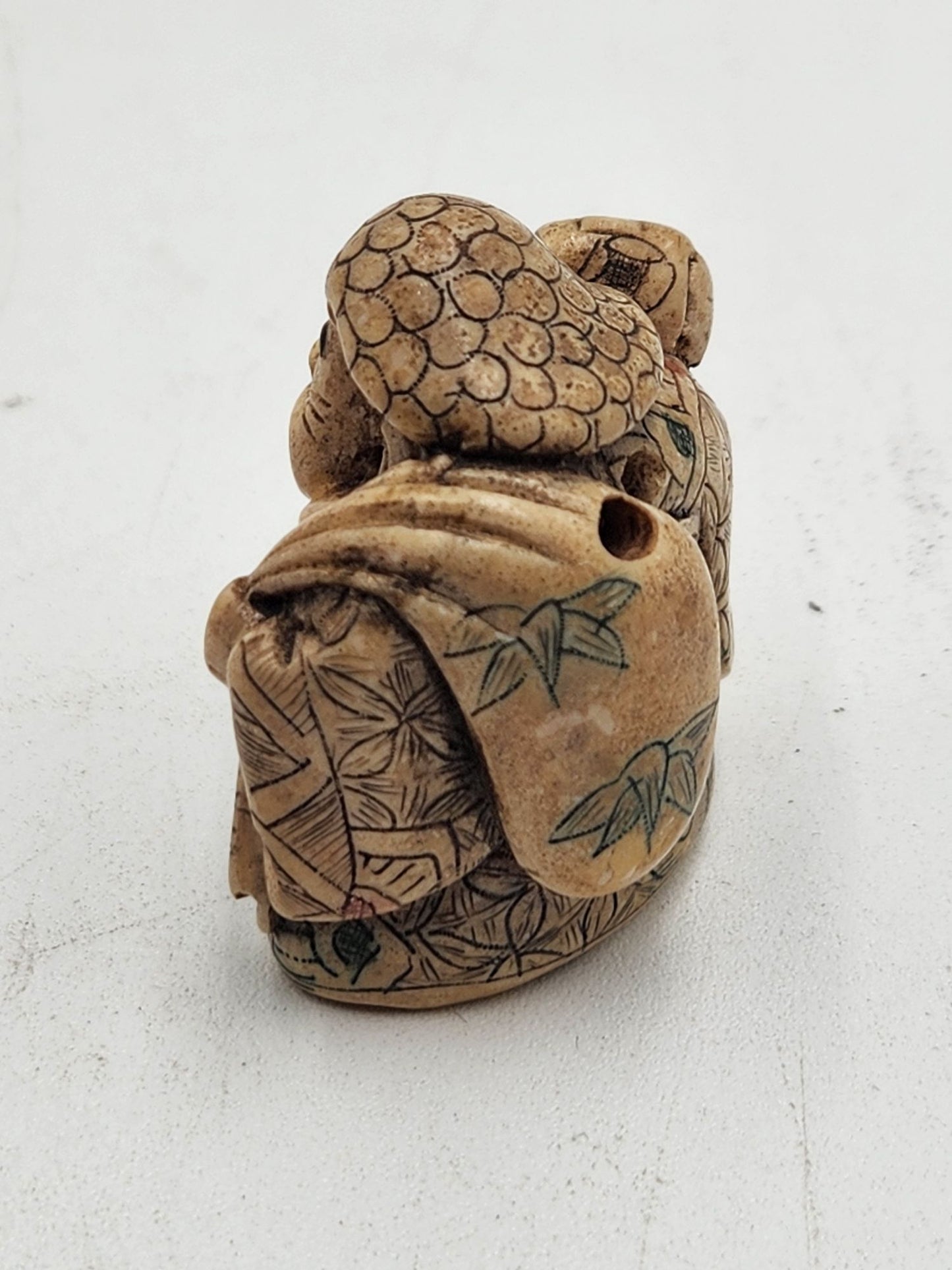 Netsuke Figurine Guy with a Mallet Crouching with a Bag