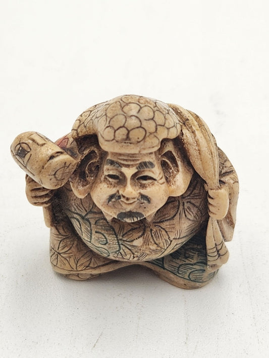 Netsuke Figurine Guy with a Mallet Crouching with a Bag