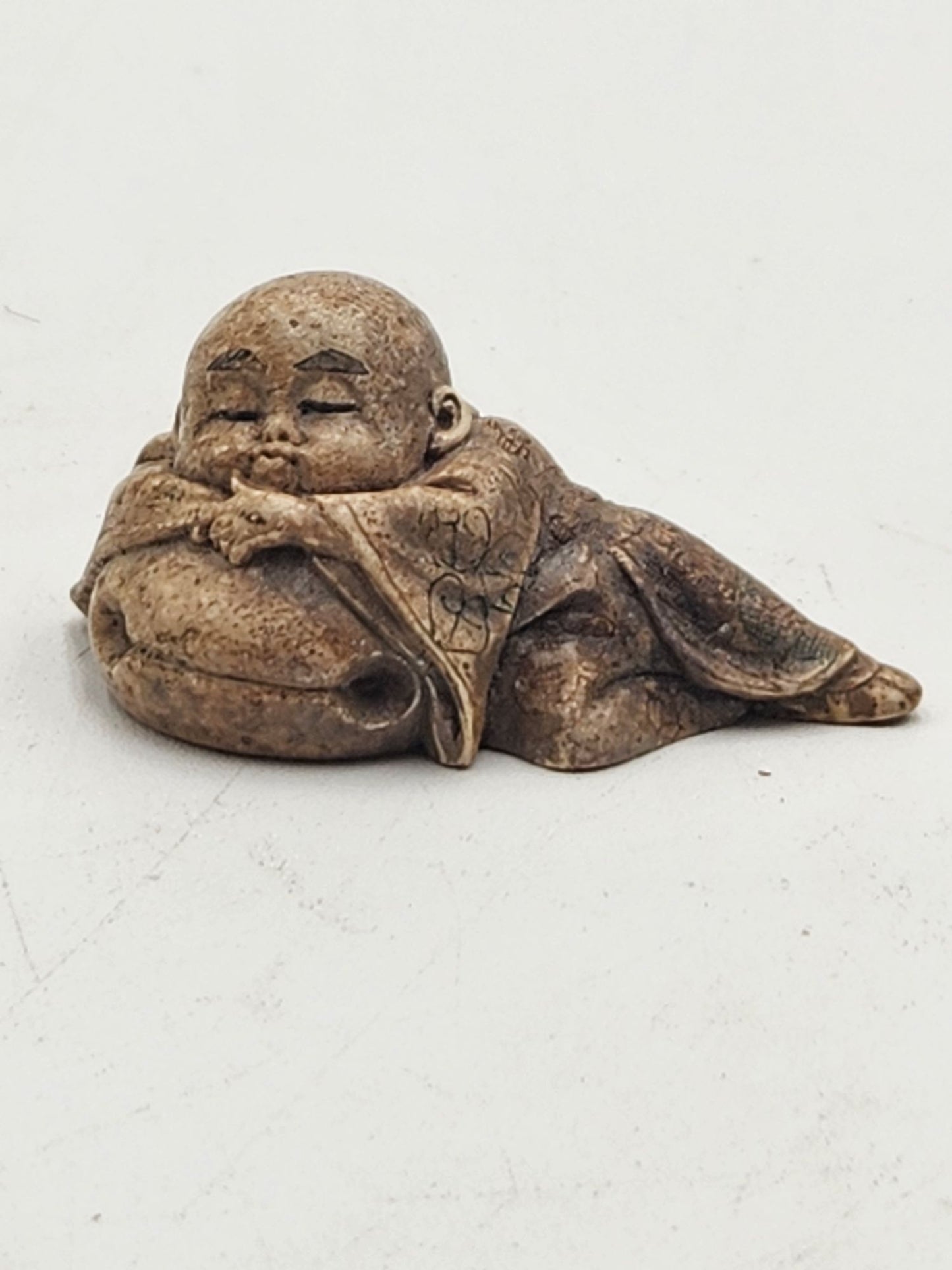 Netsuke Figurine 02 Kid Sleeping on a Bell